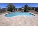 Large pool with travertine deck, lush landscaping, and a backyard basketball court at 514 E Pearce Rd, Phoenix, AZ 85042