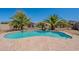 An inviting kidney-shaped pool is surrounded by lush greenery and an expansive patio area at 514 E Pearce Rd, Phoenix, AZ 85042