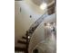 Elegant curved staircase with decorative iron railing leads to the upper level, creating a grand entrance at 514 E Pearce Rd, Phoenix, AZ 85042