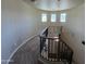 A curved staircase with iron railings leads to the next level, complemented by natural light from three windows at 514 E Pearce Rd, Phoenix, AZ 85042
