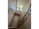 Grand curved staircase with wood banister and wrought iron spindles offers a stunning architectural detail at 514 E Pearce Rd, Phoenix, AZ 85042