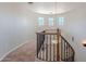 Staircase featuring a decorative wrought iron railing and view of the upper windows at 514 E Pearce Rd, Phoenix, AZ 85042