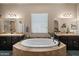 Luxurious bathroom with a large soaking tub and dual vanities at 514 E Pearce Rd, Phoenix, AZ 85042