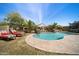 Sparkling pool with sun loungers and palm trees in the backyard at 514 E Pearce Rd, Phoenix, AZ 85042