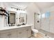 Updated bathroom with dual sinks, modern fixtures, and a glass-enclosed shower with unique tile at 5350 N 3Rd Ave, Phoenix, AZ 85013