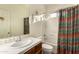 Bathroom with shower-tub combo, stylish shower curtain, and tiled countertop at 5423 W Range Mule Dr, Phoenix, AZ 85083