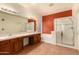 Large bathroom with double vanity, soaking tub, and glass-enclosed shower at 5423 W Range Mule Dr, Phoenix, AZ 85083