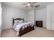 Bright bedroom with a decorative bed, a ceiling fan, and dresser at 5423 W Range Mule Dr, Phoenix, AZ 85083