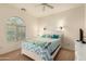 Bright bedroom with a large arched window and a comfortable queen-sized bed at 5423 W Range Mule Dr, Phoenix, AZ 85083