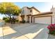 Attractive home featuring stucco siding, a terracotta roof, a two-car garage, and desert landscaping at 5423 W Range Mule Dr, Phoenix, AZ 85083
