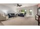 Bright living room features a large window, comfortable sofas, and a ceiling fan at 5423 W Range Mule Dr, Phoenix, AZ 85083