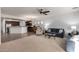 Open-concept living room flows into kitchen with stainless steel appliances and breakfast bar seating at 5423 W Range Mule Dr, Phoenix, AZ 85083