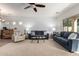 Spacious living room with neutral carpet, sofas, and a ceiling fan at 5423 W Range Mule Dr, Phoenix, AZ 85083