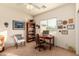Bright office space with neutral walls, a ceiling fan, and a wooden desk at 5423 W Range Mule Dr, Phoenix, AZ 85083
