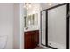 Bathroom with a dark vanity, a glass door shower and a mirror with decorative lighting at 5450 E Deer Valley Dr # 3003, Phoenix, AZ 85054