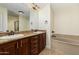 Bathroom with double sink vanity, dark wood cabinets and separate soaking tub at 5450 E Deer Valley Dr # 3003, Phoenix, AZ 85054
