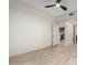 Spacious bedroom with light wood flooring, ceiling fan, and view to the kitchen at 5450 E Deer Valley Dr # 3003, Phoenix, AZ 85054