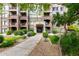 Inviting condo building facade with stone accents and a well-maintained landscaped entrance at 5450 E Deer Valley Dr # 3003, Phoenix, AZ 85054