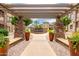 View of a courtyard through a pergola entrance, featuring a fountain and lush landscaping at 5450 E Deer Valley Dr # 3003, Phoenix, AZ 85054