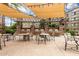 Community grilling area with multiple grills, tables, and chairs, covered by pergola at 5450 E Deer Valley Dr # 3003, Phoenix, AZ 85054