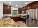 Updated kitchen features stainless steel appliances, dark cabinets, and granite countertops at 5450 E Deer Valley Dr # 3003, Phoenix, AZ 85054