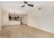 Open-concept living space with wood floors and adjacent kitchen with breakfast bar at 5450 E Deer Valley Dr # 3003, Phoenix, AZ 85054