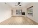 Spacious living room with modern flooring, a fireplace, and a window view at 5450 E Deer Valley Dr # 3003, Phoenix, AZ 85054