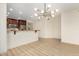 Bright living room features an updated kitchen with stainless steel appliances and modern chandelier at 5450 E Deer Valley Dr # 3003, Phoenix, AZ 85054