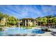 Beautiful community pool with lounge chairs and seating areas under a sunny blue sky at 5450 E Deer Valley Dr # 3003, Phoenix, AZ 85054