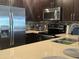Well-equipped kitchen featuring stainless steel appliances, dark wood cabinets, and stylish backsplash at 5450 E Deer Valley Dr # 3183, Phoenix, AZ 85054