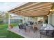 Relax on the charming brick back patio, featuring a covered seating area and lush green lawn at 6111 N 8Th St, Phoenix, AZ 85014