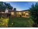 Evening shot of the inviting backyard, complete with a covered patio and lush landscaping at 6111 N 8Th St, Phoenix, AZ 85014