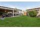 Well-manicured backyard featuring a patio, outdoor furniture, and lush green lawn at 6111 N 8Th St, Phoenix, AZ 85014