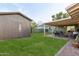 Green backyard featuring a patio, outdoor furniture, lush green lawn and storage shed at 6111 N 8Th St, Phoenix, AZ 85014