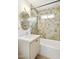 Bathroom featuring shower over tub with green tile, vanity, and rounded mirror at 6111 N 8Th St, Phoenix, AZ 85014