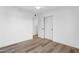 Bright bedroom featuring light hardwood floors, a ceiling fan, and a closet with sliding doors at 6111 N 8Th St, Phoenix, AZ 85014
