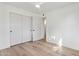 Bright bedroom features light hardwood floors, ceiling fan and closet with mirrored sliding doors at 6111 N 8Th St, Phoenix, AZ 85014