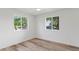 Bright bedroom featuring wood-look floors and bright windows offering neighborhood views at 6111 N 8Th St, Phoenix, AZ 85014