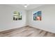 Sunlit bedroom featuring wood-look floors and bright windows offering neighborhood views at 6111 N 8Th St, Phoenix, AZ 85014