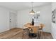 Inviting dining area featuring a round wooden table and wicker chairs beneath a pendant light at 6111 N 8Th St, Phoenix, AZ 85014