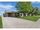 Well-maintained exterior of a single-story home with a long driveway and mature trees at 6111 N 8Th St, Phoenix, AZ 85014