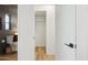 Hallway view leading to a bathroom with a modern toilet and closet at 6111 N 8Th St, Phoenix, AZ 85014