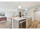A bright kitchen featuring a spacious island with stainless steel appliances and modern pendant lights at 6111 N 8Th St, Phoenix, AZ 85014
