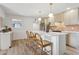 Bright kitchen featuring an island with seating, modern pendant lighting, and light-colored cabinetry at 6111 N 8Th St, Phoenix, AZ 85014