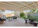 A cozy covered patio with brick flooring, outdoor seating, and a well-maintained backyard at 6111 N 8Th St, Phoenix, AZ 85014