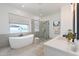 Luxurious bathroom with a freestanding tub, glass-enclosed shower, and dual vanity at 6514 W Apex Ave, Queen Creek, AZ 85144