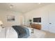 Bright bedroom features a mounted TV, sleek dresser, and soft decorative textures at 6514 W Apex Ave, Queen Creek, AZ 85144