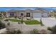 Stunning home boasts desert landscaping, a three-car garage, and a charming facade at 6514 W Apex Ave, Queen Creek, AZ 85144