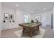 Bright game room features a billiard table, neutral walls, and decorative artwork at 6514 W Apex Ave, Queen Creek, AZ 85144