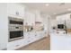 Modern kitchen featuring stainless steel built-in appliances and a white tile backsplash at 6514 W Apex Ave, Queen Creek, AZ 85144